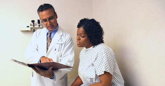 doctor showing a patient a document in their file